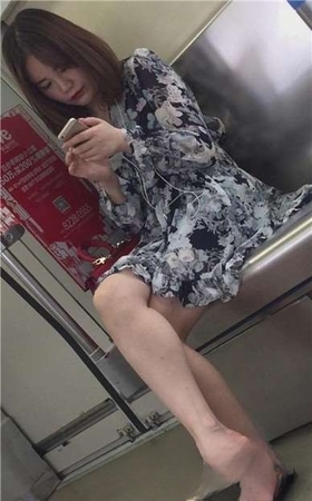 地铁上拍摄颜值超高的长腿妹子，一直低头玩手机。